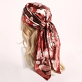 Detail of floral satin scarf styled as headscarf with vintage floral pattern - Brown Border
