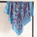 Detail of light blue paisley satin silk scarf hanging on a metal display stand - Light Blue Pink Floral (FT248-7)
