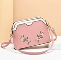 Pink and beige shell-shaped shoulder bag featuring floral embroidery and adjustable strap - Pink
