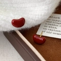 Polished dark red bean-shaped stud earrings with gold pins on leather and wool texture - Rounded Bean Stud Earrings (A-464) / Ancorra Red