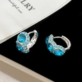 Detail of blue zircon hoop earrings with silver finish on a premium display background - C-Shaped Semi-Hoop Style / Dark Blue Rhinestone Ear Clip (A-602)