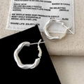 Minimalist silver matte twisted hoop earrings set on fabric for a modern stylish look - Matte Twist Earrings (A-1351)