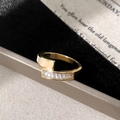 Close-up of golden wrap ring featuring rectangular crystals and cream enamel finish - Gold Shell Ring / Gold