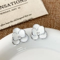Detailed view of silver-edged white flower stud earrings with a sparkling zircon center - White Flower (A-1644)