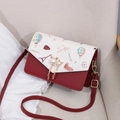 Women's crossbody bag with red and cream contrast design and city landmark print - Red