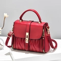 Fashionable red square handbag with V-quilted pattern and gold rotating clasp on stand - Burgundy