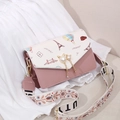 Pink crossbody bag with Eiffel Tower prints, pearl cat charm, and wide patterned strap - Pink
