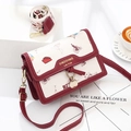 Cute red and white crossbody bag with travel illustration and gold brand logo - Burgundy
