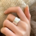 Macro view of wide wavy silver ring featuring a brushed matte texture on hand - Wavy Irregular Edge Brushed Style (C-182) / Silver