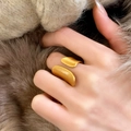 Elegant gold leaf brushed ring worn by a model against a warm luxury fur background - Leaf Shaped Open Brushed Style (C-97) / Gold
