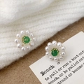 Detail of flower stud earrings featuring green stone center and white pearl petals - A-1109-Green Center Studs