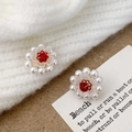 Detailed close-up of handmade floral earrings with white pearls and red beads on fabric - A-1109-Red Center Studs