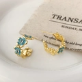 Detail of C-shaped gold earrings with light blue enamel flowers and crystal accents - Blue Enamel Flower Hoop Earrings (A-1438)
