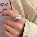 Close-up of minimalist silver wave ring with liquid metal design on a model's hand - Silver Wavy Ring (C-419) / Silver