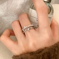 Detail of silver pearl ring set with layered star charm worn in a lifestyle setting - Bright Pearl Starburst Double Layer Silver Ring (C-423)