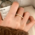 Elegant gold ring with small white pearls and crystals on a model's finger - Bright Pearl Gold Ring (C-155)