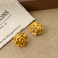 Detailed macro view of gold-finished matte flower earrings with brushed metal texture - 3D Rose Flower Style (A-1539)