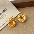Detail view of twisted matte gold hoop earrings with vintage texture on rustic background - Multi-circle Twisted Ring Style (A-1368)
