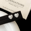 Macro detail of heart-shaped silver earrings with sparkling stones on a black velvet stand - Silver Heart Style (A-616)
