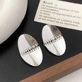 Macro shot of silver oval stud earrings featuring a unique horizontal stitched design - Chain Texture Oval Patchwork Style (A-1796-Silver)