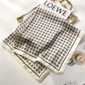 Detailed view of luxury cream silk scarf with black G pattern on golden tray - Off-white with Black Border (FJ680-4)