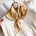 Golden brown geometric silk scarf tied with a white camellia brooch on a white shirt - 76x13cm / Golden Brown Geometric Chain
