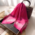 Elegant rose patterned silk scarf draped on a leather handbag with a minimalist backdrop - 70x70cm / Rose Red