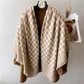 Brown houndstooth cashmere shawl with tassels over a wool coat for winter warmth - Camel