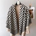 Macro shot of houndstooth scarf texture with fringe detail and camel wool coat - Black and White