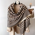 Thick houndstooth scarf with tassels and beige contrast trim draped on a coat - Black Apricot