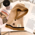Detail of knitted hood scarf with buttons and HILLDI brand patch in cozy autumn setting - Beige Yellow and Brown