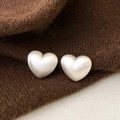 Macro shot of minimalist silver heart studs with a brushed matte metallic texture - Heart-shaped Brushed Style (A-1588)