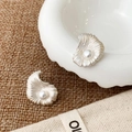 Detailed view of silver shell stud earrings with central white pearl on linen fabric - Silver Pearl Shell Studs (A-382)