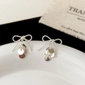 Close-up of silver bow stud earrings with dangling polished metal sequins in detail - Sequin Tassel Bowknot Style (A-1399)