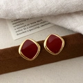 Close-up of vintage gold-plated square stud earrings with dark red enamel glaze finish - Irregular Square Style (A-1900)