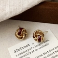 Detailed macro view of vintage gold twisted knot earrings with burgundy and khaki enamel - Spiral Knot Style (A-303)