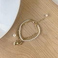 Detail view of multi-layer gold chain bracelet with pearls and heart pendant - Real Gold Plated