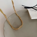 Detail of elegant gold double-layered necklace featuring beaded and snake chains - Gold Double Layer Wrapped Necklace
