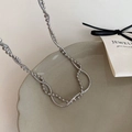 Detail of silver double layer necklace featuring bead and snake chains on ceramic plate - Silver Double Layer Wrapped Necklace