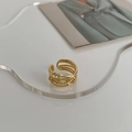 Detailed view of layered gold braided ring with twisted wire design on acrylic stand - Braided Ring / Gold