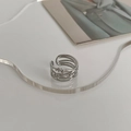 Close-up of silver minimalist irregular woven wire ring on transparent display - Braided Ring / Silver
