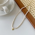 Detailed view of baroque pearl necklace with a polished gold heart pendant and lobster clasp - Heart Natural Freshwater Pearl Necklace