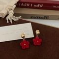 Detailed shot of red five-petal flower drop earrings with elegant gold stud finish - Red Flower Studs