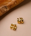 Detailed macro view of gold-plated triple-layer C-shaped hoop earrings with metal hallmark - Gold