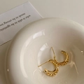 Detail of gold irregular C-shaped hoop earrings with beaded edges on a ceramic plate - Gold Irregular Geometric C-shape Earrings
