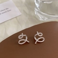 Detailed macro shot of criss-cross ribbon earrings with sparkling pavé cubic zirconia - Silver Spiral Twist Stud Earrings