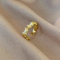Detail of gold butterfly ring with white zircons on premium champagne silk fabric - Gold