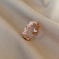 Close-up of rose gold butterfly ring with pave-set zircon crystals on champagne silk - Rose Gold