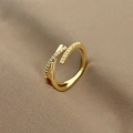 Macro view of gold crisscross ring featuring intricate pavé cubic zirconia setting - Gold