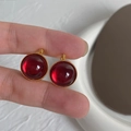 Detail of ruby glass pendant with golden beaded edge craftsmanship and transparent texture - Ruby Red